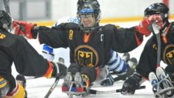 Photo: Frank Rennhack with his team mates on the ice during a Para Ice Hockey game; Copyright: IPC