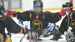 Photo: Frank Rennhack with his team mates on the ice during a Para Ice Hockey game; Copyright: IPC